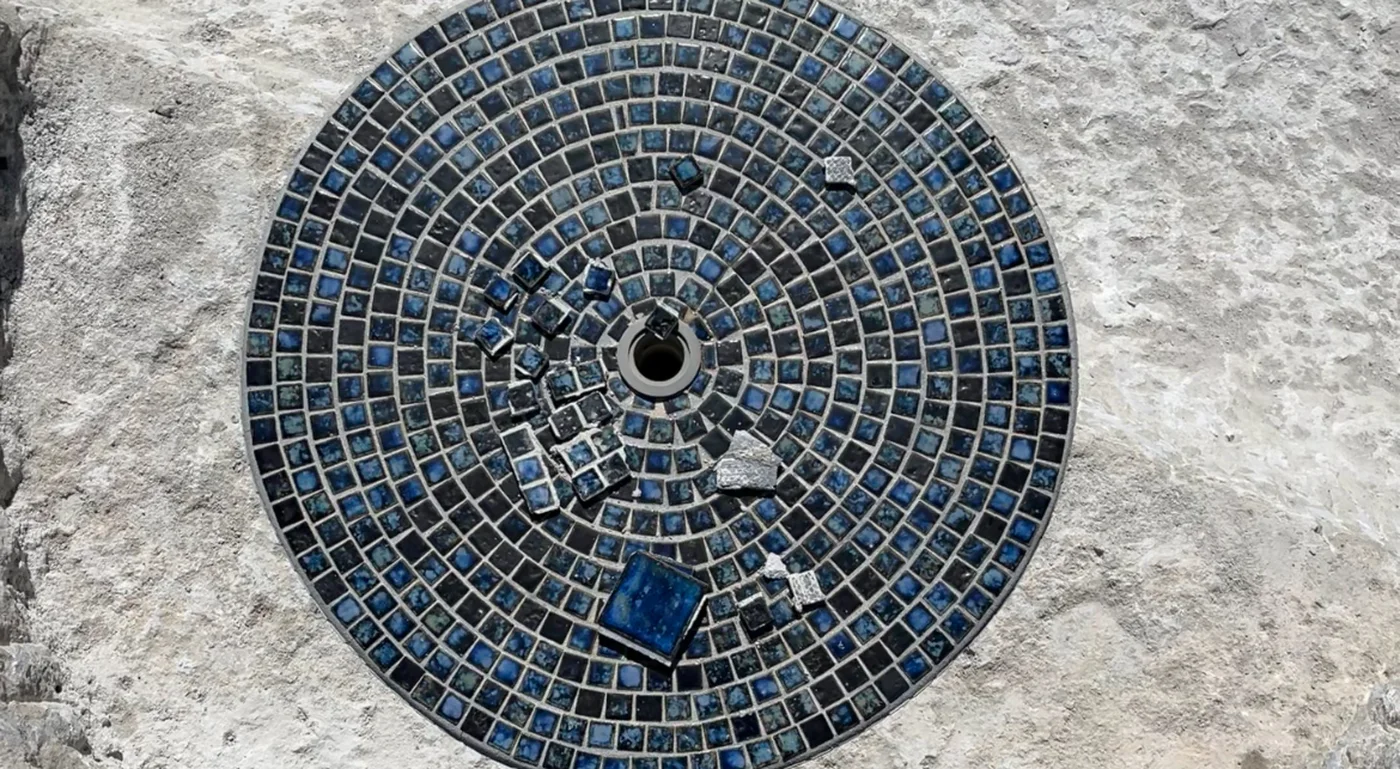 Custom blue mosaic tile detail on a redesigned swimming pool