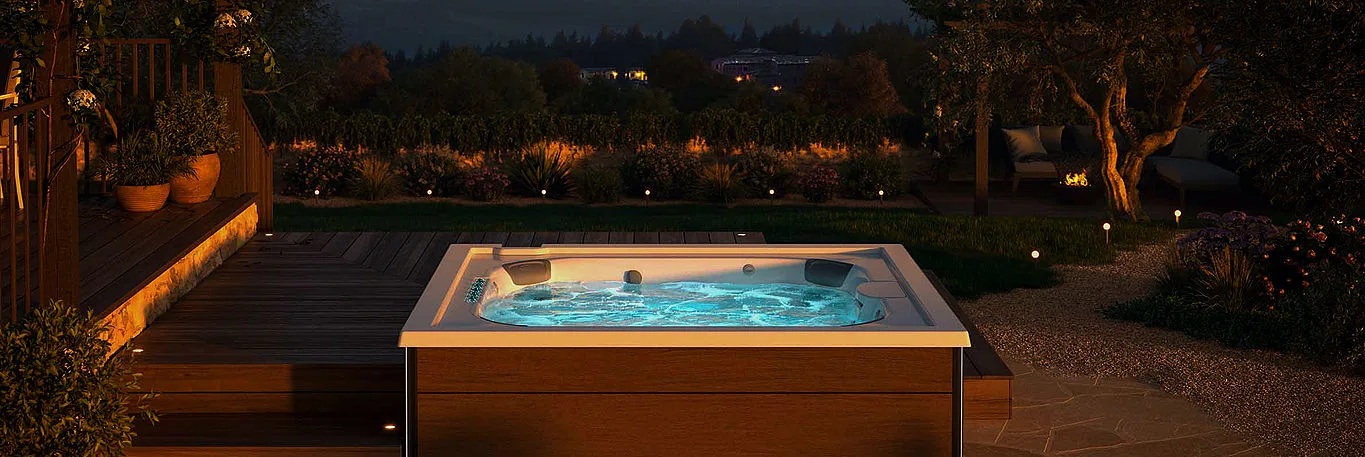 Illuminated backyard jacuzzi at night