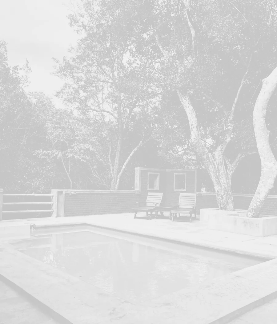 Backyard pool with lounge chairs maintained by GK Swimming Pools