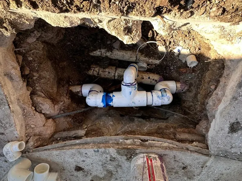 Replaced PVC pool plumbing in an excavated trench beside the pool deck